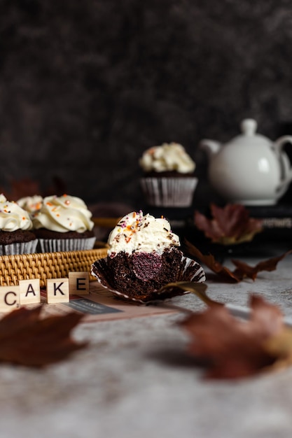 Chocolate cupcakes in a wicker basket One cupcake cut with a fork