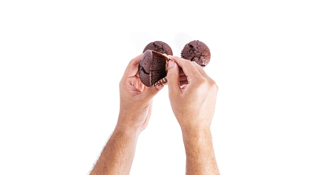 Chocolate cupcakes with cherry jam isolated on a white background. Chocolate muffin in hand. High quality photo