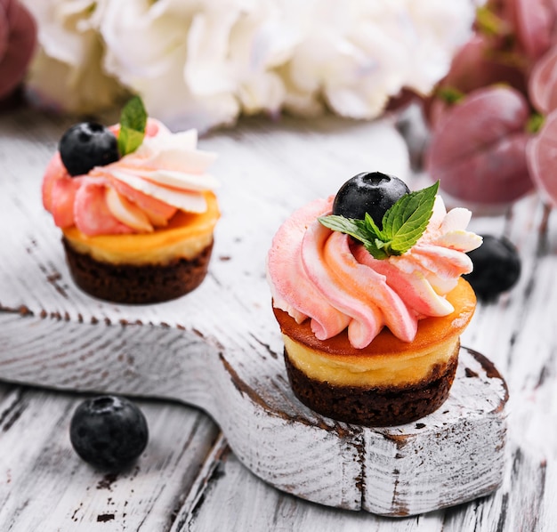 Chocolate cupcakes with pink cream and fresh blueberry