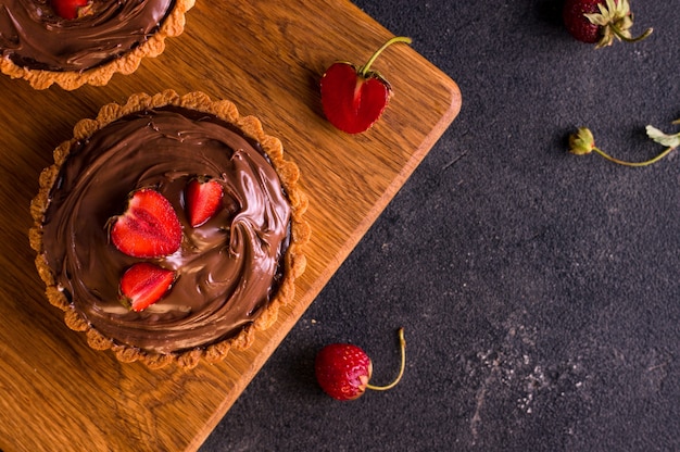 Chocolate dessert. Berry tart. Copy space. Dark background