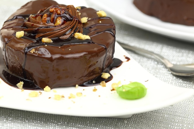 Chocolate dessert with decoration on white plate