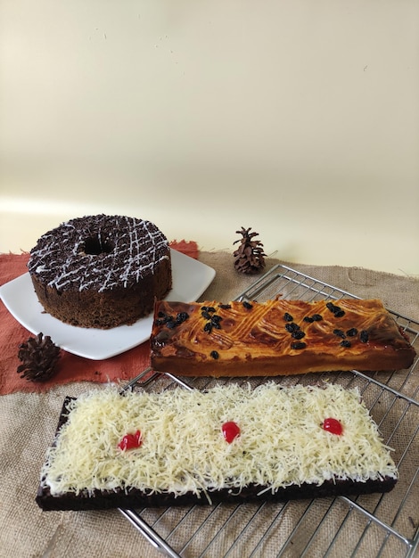 A chocolate donut with white chocolate and red berries on top of it.