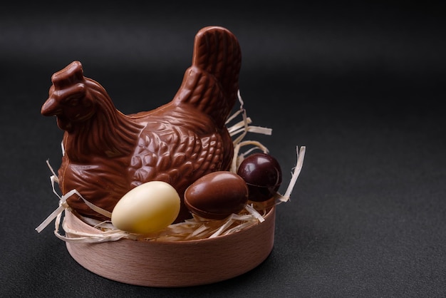 Chocolate Easter hen and eggs in a nest with straw