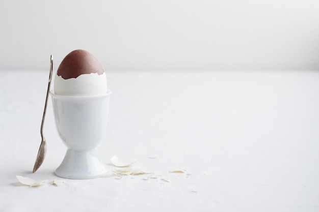 Chocolate egg on white eggstand holder