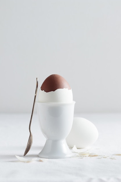 Chocolate egg on white eggstand holder