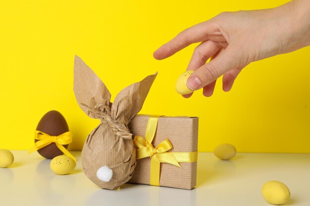 A chocolate egg in a wrapper and with a gift