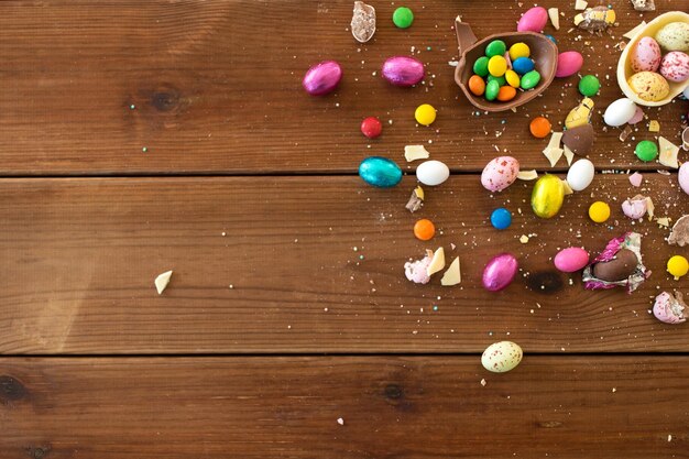 chocolate eggs and candy drops on wooden table