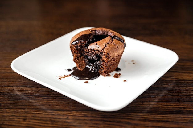 Chocolate fondant dessert on a white plate and a fork