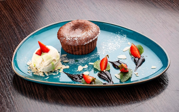 Chocolate fondant with ice cream balls On a wooden background