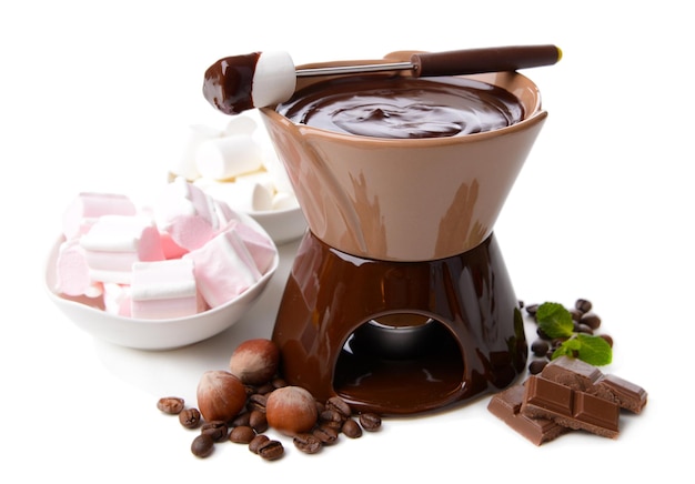 Chocolate fondue with marshmallow candies isolated on white