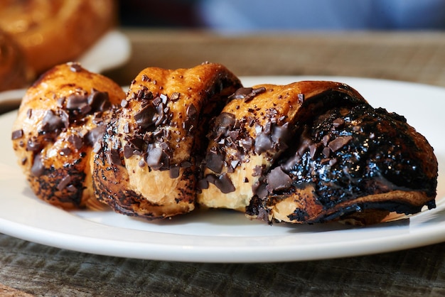 Chocolate french croissant on a white plate. Home baked puff pastry rolls