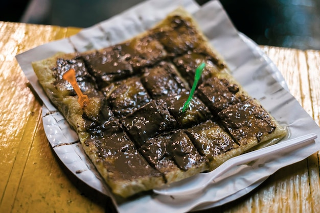 Chocolate fried sweet thai pancake with banana cut into pieces thai fast food street lifestyle real