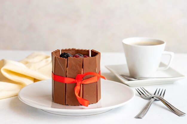 Chocolate fruit cake on a white background Cake covered with chocolate