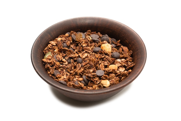 Chocolate granola cereal with nuts in a bowl isolated on white.