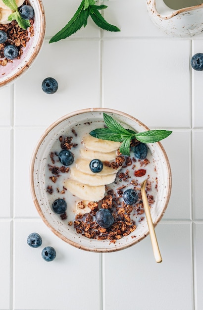 Chocolate granola and milk with blueberries banana and mint healthy food