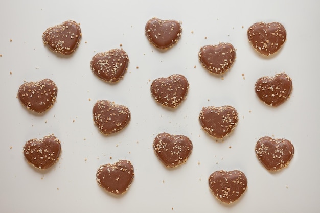 Chocolate hearts cookies pattern with sweet nuts Valentines day dessert overhead shot