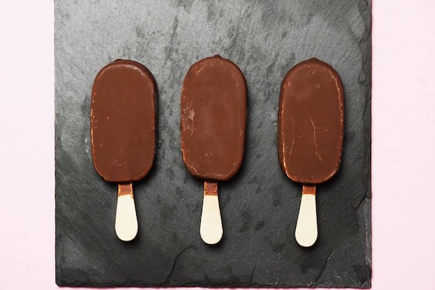 Chocolate ice cream dark slate background. flat lay. flat design. gastronomic food