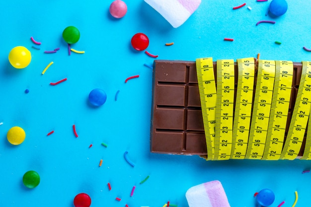 Chocolate is wrapped in a measuring tape with different sweets