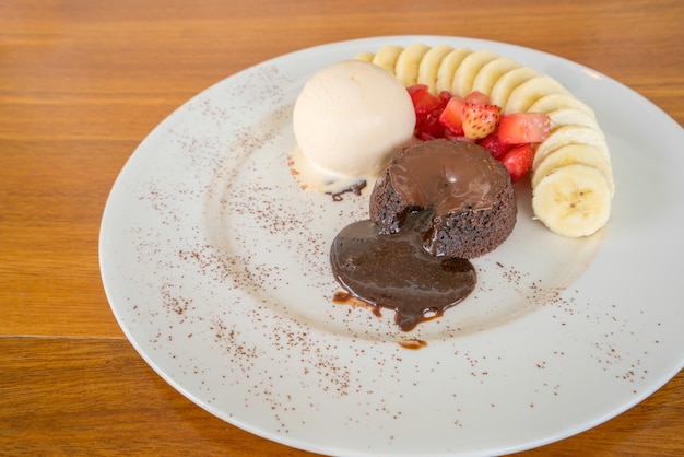 Chocolate lava cake with vanilla icecream, strawberry and banana topping