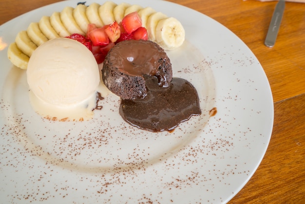 Chocolate lava cake with vanilla icecream, strawberry and banana topping