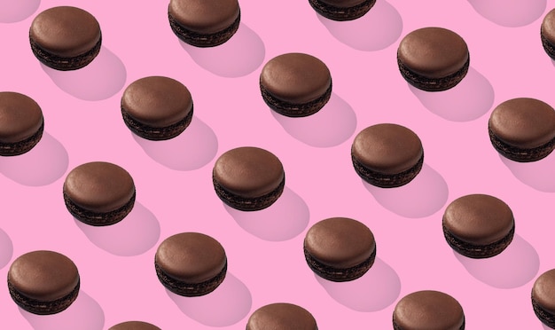 Chocolate macarons pattern on pink background isolated