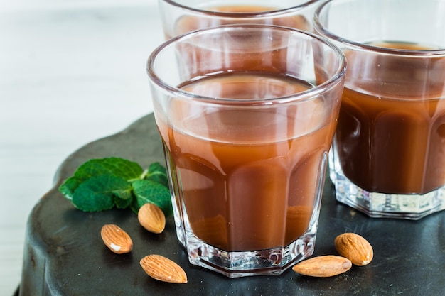 Chocolate milk in a glass on a wooden surfacexA