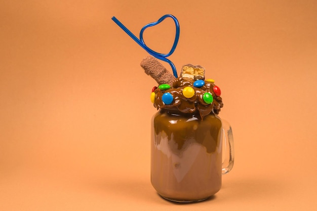 Chocolate milkshake with whipped cream cookies waffles served in glass mason jar Freak or crazy sweet shake