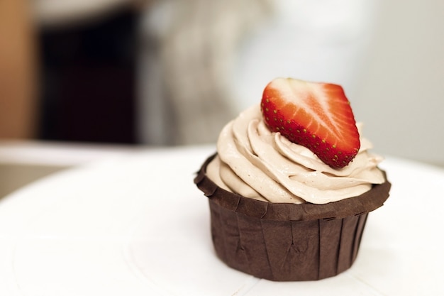 Chocolate muffin with cream and berries