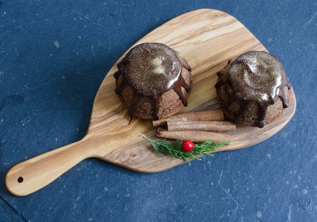 Chocolate muffin on wooden background.