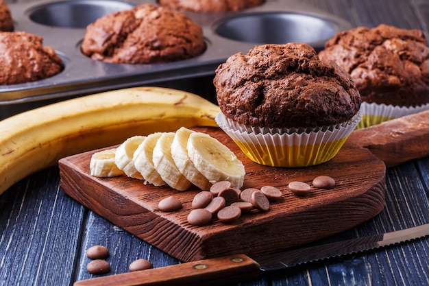 Chocolate muffins with banana on dark