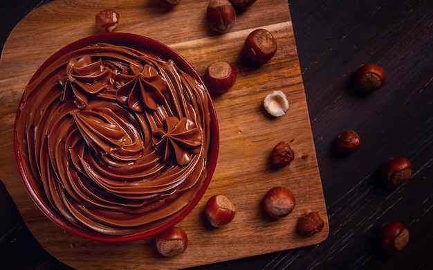 Chocolate nut paste mousse pasta in a cup on a wooden table top view selective focus no people