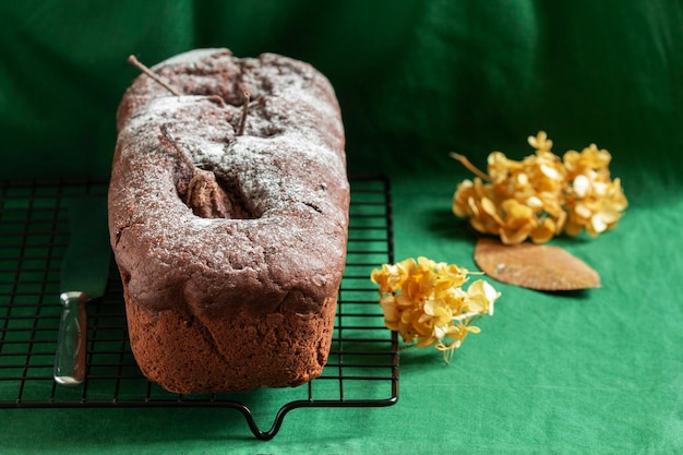 Chocolate pear cake on a green background. Rustic style, selective focus.