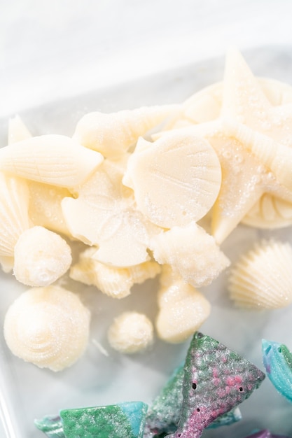 Chocolate seashells and mermaid tails in a glass container.