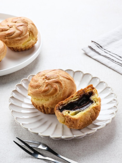 Chocolate Soes Cakes  Sus Vla  served in white plate selected focus