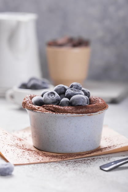 Chocolate Souffle with frozen blueberry. French traditional dessert.