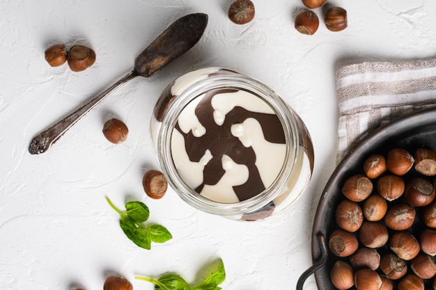 Photo chocolate spread jar set on white stone table background top view flat lay