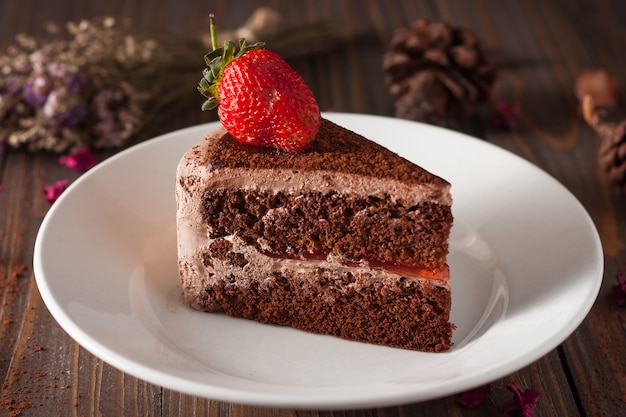 Chocolate strawberry cake on a white plate