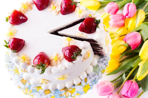 Chocolate Strawberry Lemon Torte made with 6 layers of chocolate cake, filled with lemon curd and strawberry mousse, covered in white chocolate cream cheese frosting.