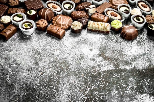 Chocolate sweet candies. On the rustic background.