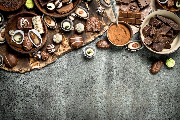 Chocolate sweets with cocoa powder. On a rustic background.