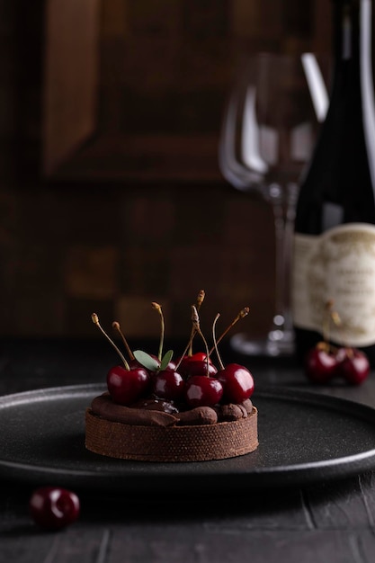 Chocolate tart with ganache decorated with cherry