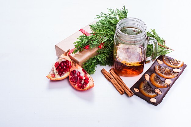 Chocolate, tea, pomegranate and cinnamon isolated on white