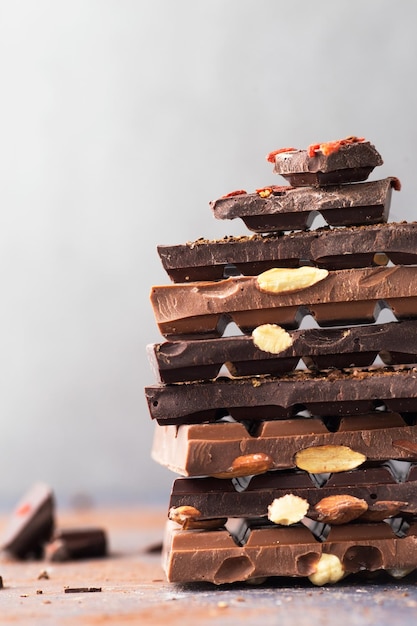 Chocolate tower Dark and milk chocolate bars with nuts berries and coffee beans