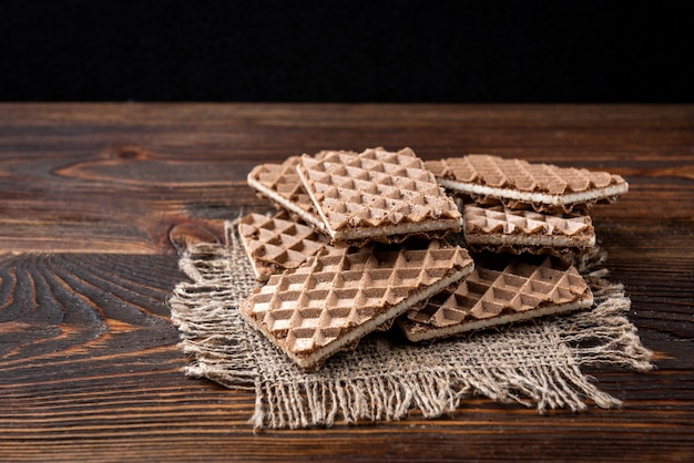 Chocolate waffles with milk filling on table