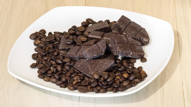 Chocolate with coffee beans on a white plate