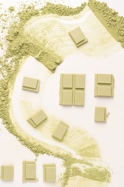 Chocolate with matcha tea on a white background. View from above