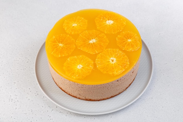 Chocolateorange mousse cake with biscuit base jelly and orange circles Whole homemade cheesecake Traditional holiday dessert Selective focus closeup