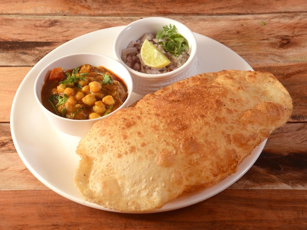 Chole Bhature spicy Chick Peas curry also known as Chole or Channa Masala is traditional North Indian main course recipe and usually served with fried puri or Bhature selective focus