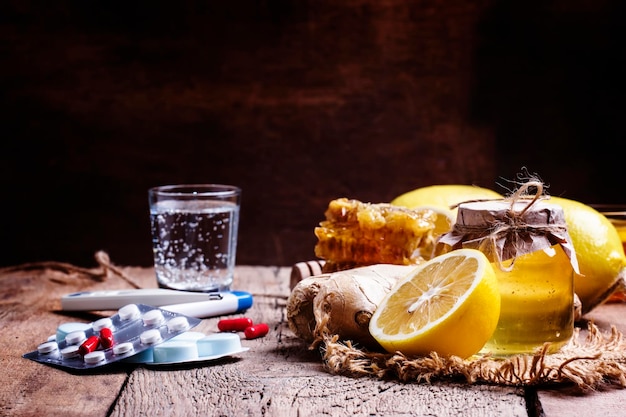 Choose between drugs for colds and flu traditional tablets and alternative natural remedies Vintage wooden background selective focus