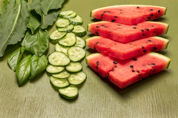 Chopped cucumber and basil leaves pieces of watermelon